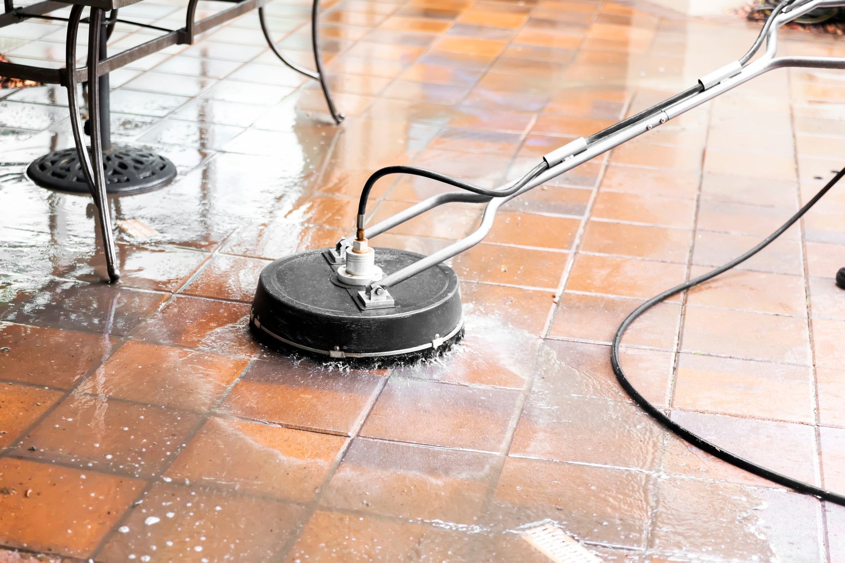 Power washing residential pool patio tiles